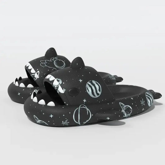 Black Cosmic Shark Slides adorned with space-inspired patterns including planets and stars, crafted for comfort and style. Shop at CloudSharks.shop.