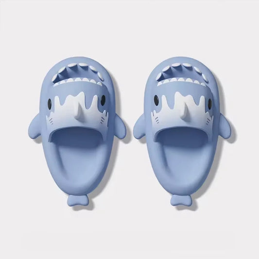 A pair of blue Cloudsharks shark slides with a cute, open-mouthed shark design, highlighting the white, ice cream-like "melt" detail on the top.