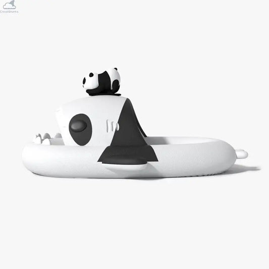 Side profile of white and black Panda Family Shark Slides by Cloudsharks showing thick cushioned cloud soles, shark teeth, and a 3D panda ornament on top. Side-view profile of the black and white Panda Family Shark Slides featuring a 3D mini panda figure resting on top of the shark's head.
