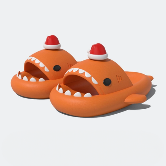 Orange Christmas Shark Slides on a glossy, wet surface, demonstrating the slip-resistant sole. Chinese text translates to: 'Every step is very stable, easily navigating slippery ground.