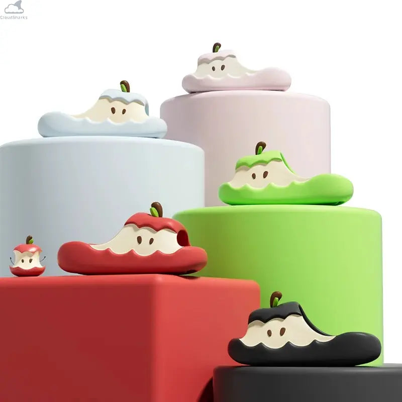 Various color options of Apple Cloud Slides displayed on colorful studio pedestals, including red, green, black, and pastel shark slides.