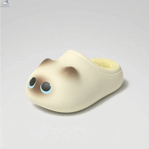 A single, detailed beige cat-shaped house slipper with large blue-lined eyes, brown ears, and a soft yellow fuzzy interior, shown at a three-quarter angle on a neutral background, serving as a cute alternative to typical shark slides or shark slippers from Cloudsharks.