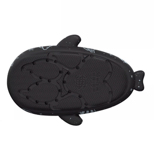 Bottom view of a black Cosmic Shark Slide, clearly displaying the deep grooves and anti-slip pattern of the sole designed for secure footing. The texture appears durable and grippy.