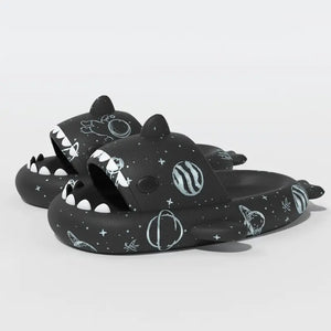 Black Cosmic Shark Slides adorned with space-inspired patterns including planets and stars, crafted for comfort and style. Shop at CloudSharks.shop.