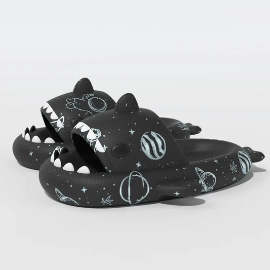 Black Cosmic Shark Slides adorned with space-inspired patterns including planets and stars, crafted for comfort and style. Shop at CloudSharks.shop.