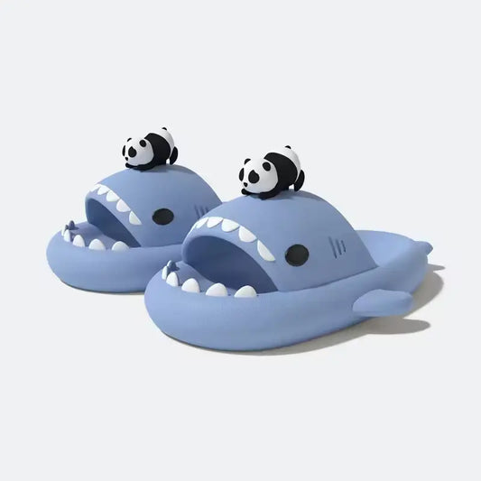 Pair of blue Panda Shark Slides with a small black and white panda charm from cloudsharks.shop. Cute and waterproof EVA slides.