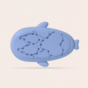 Bottom view of a light blue Unicorn Shark Slide, clearly displaying the textured anti-slip sole with a repeating wave and circular pattern for enhanced grip.