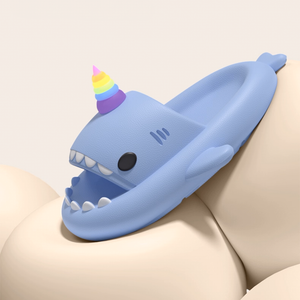 Side view of a light blue Unicorn Shark Slide featuring a vibrant rainbow unicorn horn. The slide has a matte, slightly textured EVA finish, showcasing its playful design and smooth contours.