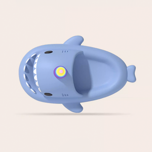 Top-down view of a light blue Unicorn Shark Slide. It shows the comfortable, contoured footbed and the subtle texture of the matte EVA material. A rainbow-colored eye is visible on the head.