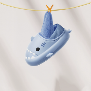 Blue waterproof shark slippers hanging to dry, lightweight winter shark slides with plush lining, easy-clean cloudsharks indoor outdoor house shoes