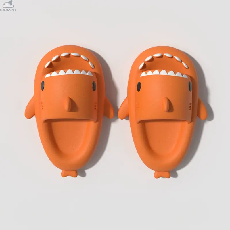 Orange CloudSharks shark slides comfortable non slip shark slippers lightweight EVA shark sandals for home bathroom and beach - CloudSharks Orange Shark Slides feature a fun shark design with ultra soft EVA foam for maximum comfort. These lightweight shark slippers are designed with a non slip sole, making them perfect for indoor use, bathroom, beach, or everyday casual wear. The bright orange color and playful shark teeth design make these shark slides a popular choice for adults and kids looking for comfo