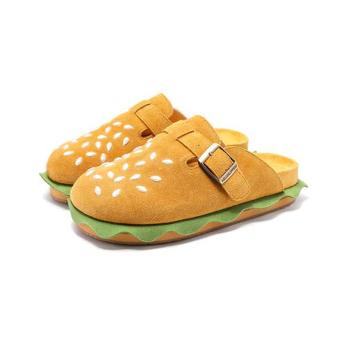 A pair of tan suede burger slippers with white sesame seed embroidery and green wavy lettuce trim, part of the Cloudsharks Friends collection.