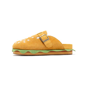 A profile shot of the burger slipper highlighting the green lettuce layer and the brown layered midsole resembling a hamburger patty.