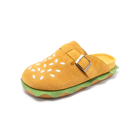 Side view of a single burger slipper showing the adjustable bronze buckle strap and layered EVA foam sole.