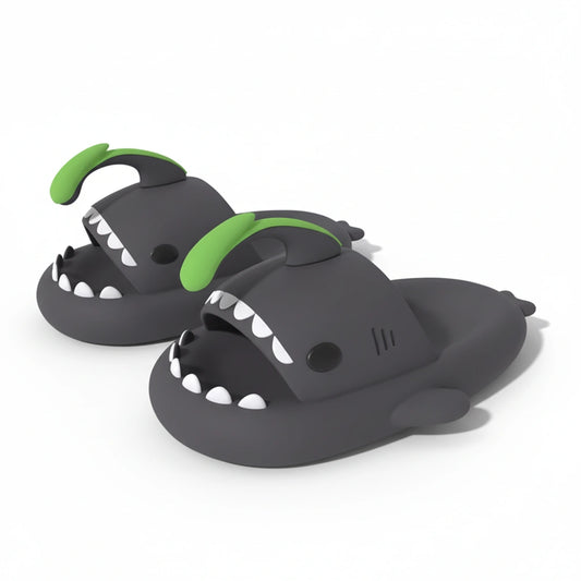 A pair of gray Cloudsharks shark slides with a vibrant green lantern fish fin, showcasing their unique, stylish, and comfortable design.