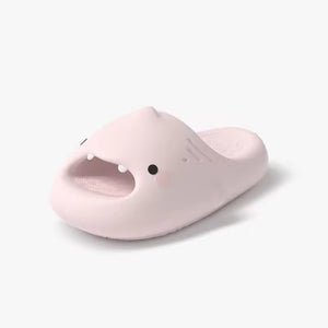 Cloudsharks™ Shark Slides in soft pink, featuring an adorable shark face with fins and tiny teeth. Comfortable and fun shark slippers for everyday wear.