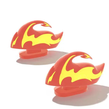 A pair of vibrant red and yellow Fire Kaiju Shark Fins, designed as snap-on accessories for Cloudsharks slides. These glow-in-the-dark attachments from cloudsharks.shop add a bold, fiery style to your footwear.