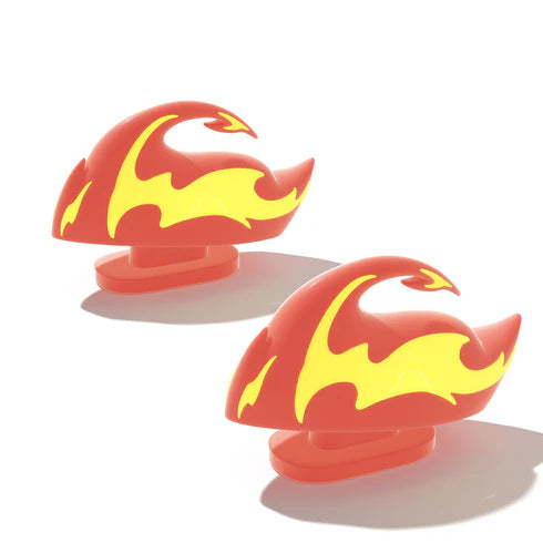 A pair of vibrant red and yellow Fire Kaiju Shark Fins, designed as snap-on accessories for Cloudsharks slides. These glow-in-the-dark attachments from cloudsharks.shop add a bold, fiery style to your footwear.