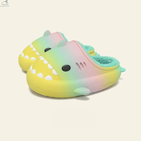 Vibrant pastel rainbow yellow green pink gradient shark slides with cozy teal plush fleece lining, cloudsharks plush house slippers. A pair of Gradient Winter Shark Slides showcasing a vibrant rainbow pastel color mix of yellow, green, and pink with a teal fleece lining.
