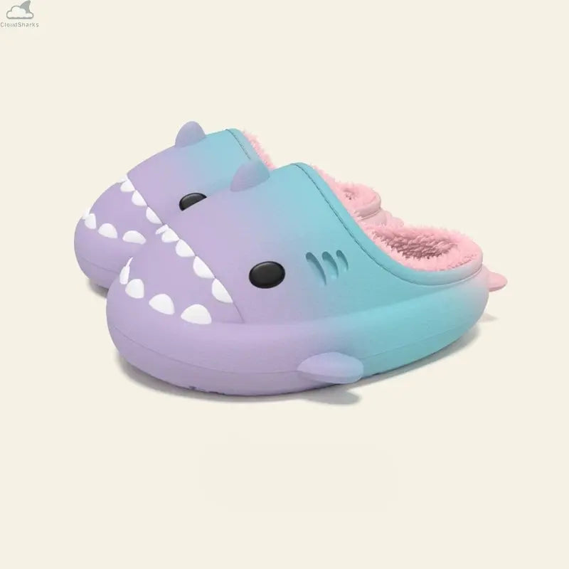 Pair of purple and cyan gradient shark slides with soft pink plush fleece lining, cloudsharks cozy indoor winter slippers. A pair of Gradient Winter Shark Slides featuring a soft purple-to-cyan gradient upper paired with a fluffy pink plush fleece interior.