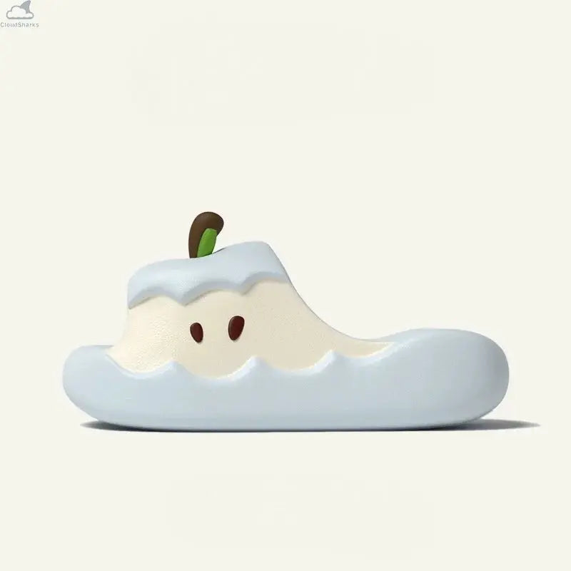 Side view of a light blue Apple Cloud Slide featuring a cream apple core design and stem, soft cloudsharks cushion comfort style.