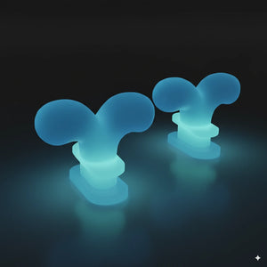 Glow-in-the-dark whale spouting fins lighting up in blue-green, designed for Cloudsharks shark slippers.