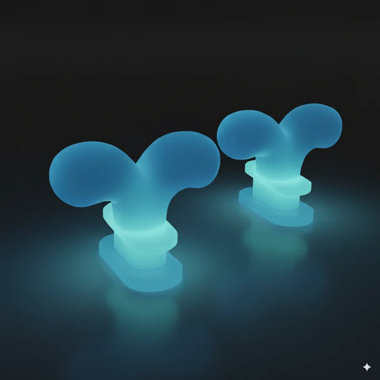 Glow-in-the-dark whale spouting fins lighting up in blue-green, designed for Cloudsharks shark slippers.