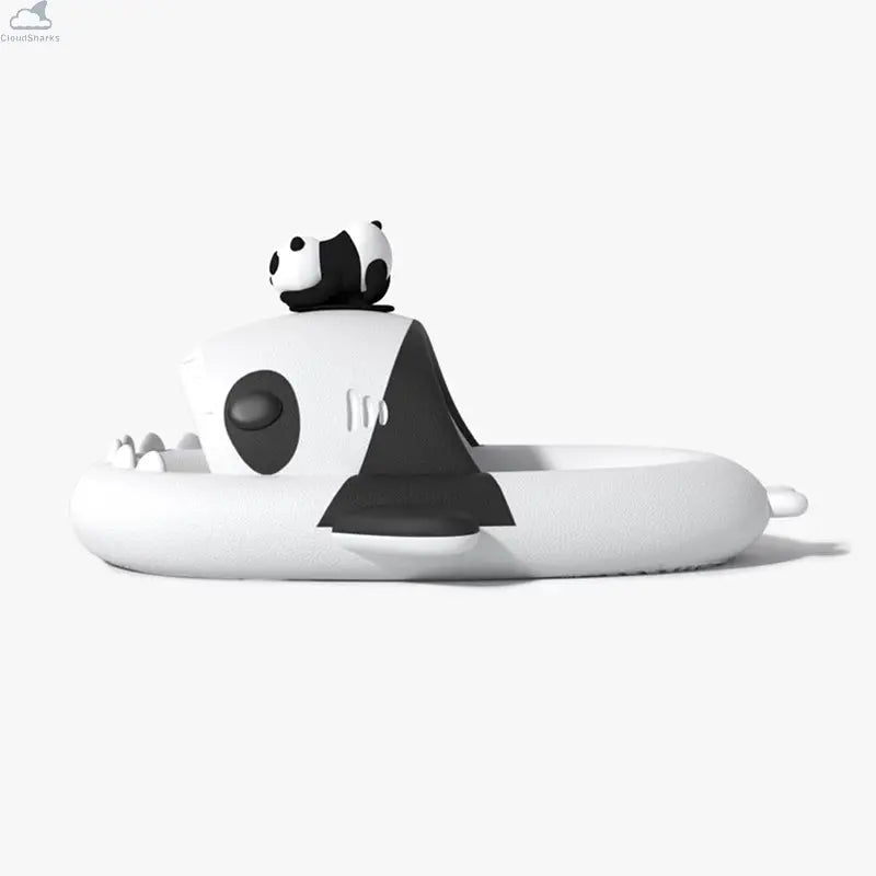 Side profile of white and black Panda Family Shark Slides by Cloudsharks showing thick cushioned cloud soles, shark teeth, and a 3D panda ornament on top. Side-view profile of the black and white Panda Family Shark Slides featuring a 3D mini panda figure resting on top of the shark's head.