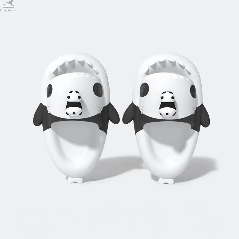 Top-down view of black and white Cloudsharks Panda Family Shark Slippers featuring cute 3D mini panda toppers, panda eye patches, and ergonomic footbeds. Top-down view of the pair of Panda Family Shark Slides featuring 3D mini pandas attached on top of the shark heads with black panda eye patches.