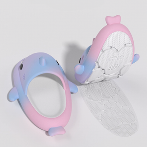 One pink and blue gradient shark slide shown from the top, revealing its comfortable footbed. Another slide is inverted, clearly displaying the textured anti-slip sole.