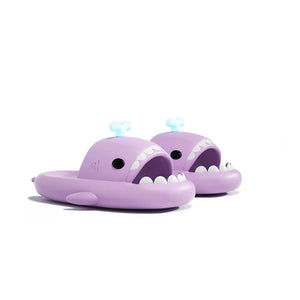Fun purple Cloudsharks whale shark slides featuring glow-in-the-dark spouting fins and playful shark teeth design.