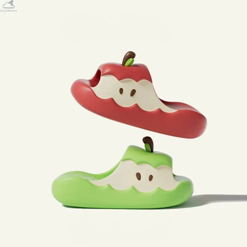 Red Apple Cloud Slide hovering above a green slide against a plain studio background, soft cloudsharks thick sole comfort.