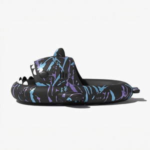 Side profile of a single black Cyberpunk Shark Slide, showcasing its thick sole for enhanced cushioning, the unique shark design, and the vibrant blue and purple splatter details.