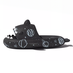 Side view of a single black Cosmic Shark Slide, emphasizing the substantial 4cm thick EVA sole and the detailed space-themed patterns. The shark's head design is prominent.