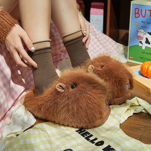 Person wearing sleepy capybara slippers from cloudsharks.shop, soft plush indoor slippers designed for cozy home vibes and cold mornings