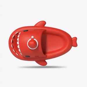 Single red shark slide viewed from the top, showing the footbed, strap, teeth, and Santa hat detail.