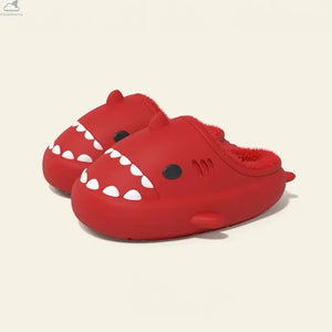 Pair of vibrant red Winter Shark Slides featuring cozy plush fleece lining, cute 3D cartoon shark teeth and fins, and thick waterproof EVA sole.