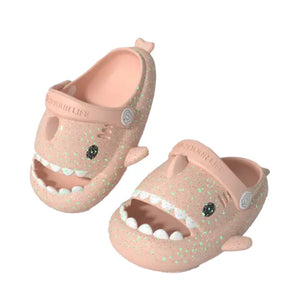 Angled pair of Cloudsharks pink shark slippers for toddlers and kids – fun glow in the dark shark slides with teeth and eyes