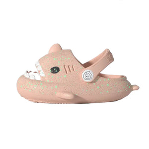 Side view of pink Cloudsharks luminous kids shark slippers with adjustable strap and fun 3D shark fins and tail