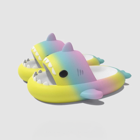 Bright yellow, pink, and blue gradient shark slippers for kids – fun and comfy EVA slides with cartoon shark look, ideal for beach or indoor use. shark slides