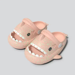 Side view of pink Cloudsharks luminous kids shark slippers with adjustable strap and fun 3D shark fins and tail